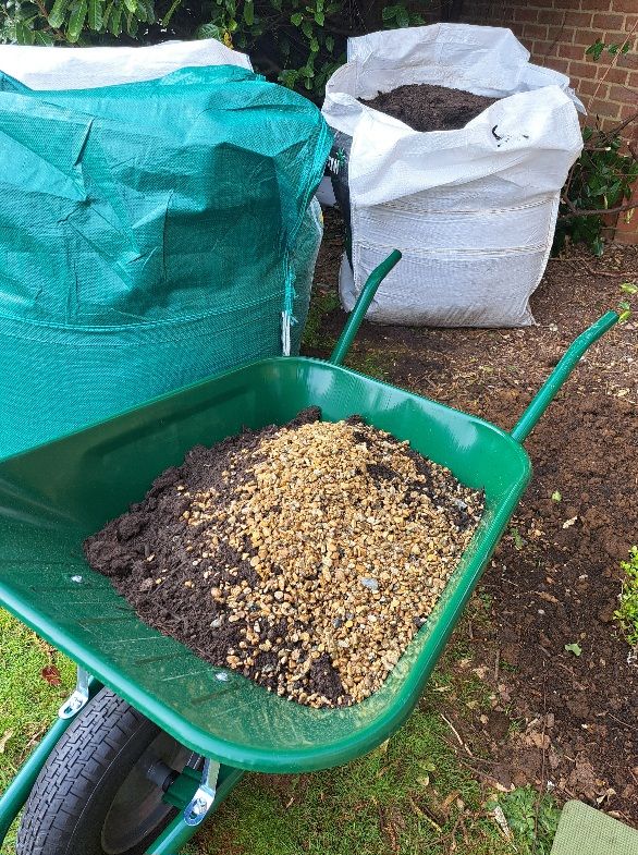 Wheelbarrow filled with mixed soil and gravel